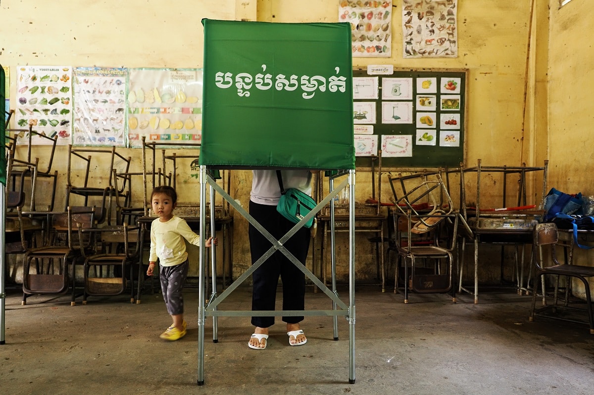 PHNOM PENH, CAMBODIA - 2023/07/23: A woman fills out her ballot at a polling station during the 2023 Cambodia's general elections. Two months before the elections, the country's main opposition, the Candlelight Party (CP), was barred by the National Election Committee (NEC) from participating in the elections. The NEC said the reason for this was that the CP had failed to submit registration documents. After the elections, the NEC reported that the ruling Cambodian People's Party (CPP) has won 120 of 125 parliamentary seats. On July 26, 2023, Cambodian Prime Minister Hun Sen, one of the world's longest ruling leaders said that he will step down, and hand over power to his eldest son, Hun Manet, who is a four-star general and commander of the Royal Cambodian Army. (Photo by Satoshi Takahashi/LightRocket via Getty Images)